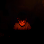 child illuminated by warm gaming glow